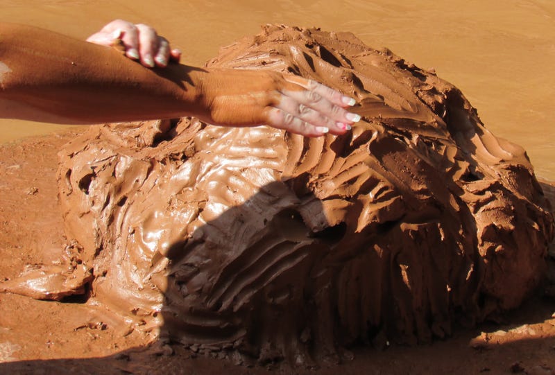 hand in red clay mud at spa