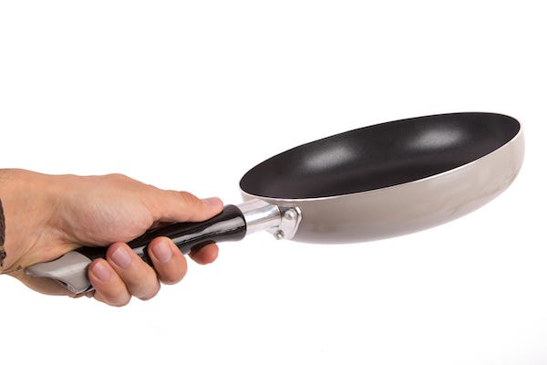 Man holding frying pan