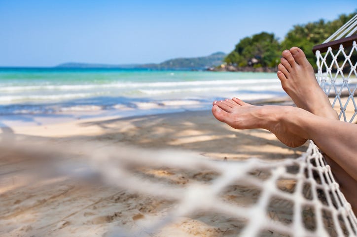 feet in a hammock on the beach