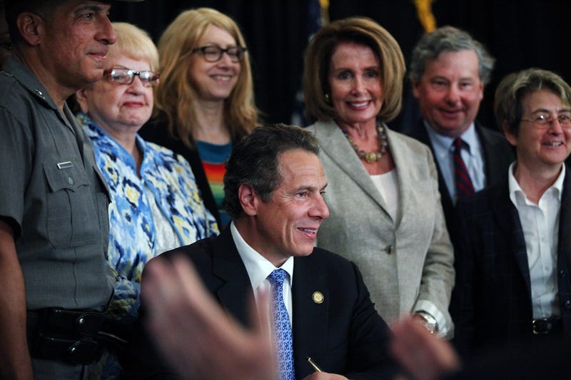File photo: Governor Andrew Cuomo, joined by then-House Minority Leader Nancy Pelosi, smiles at an event at New York University (NYU), where he signed into law a new affirmative sexual consent policy to combat campus sexual violence on July 7, 2015 in New York City