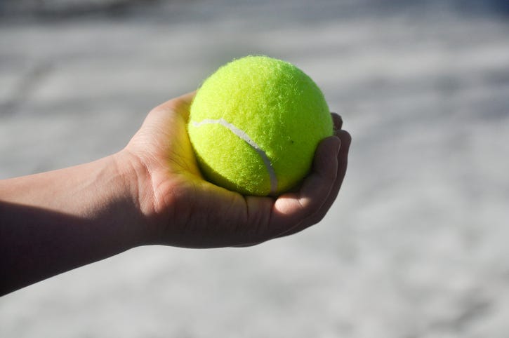 boy holding a tennis ball