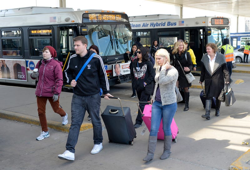 People get off buses at the Rosemont stop on the CTA Blue Line.