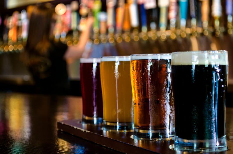 A flight of 4 craft beers lined up on the bar