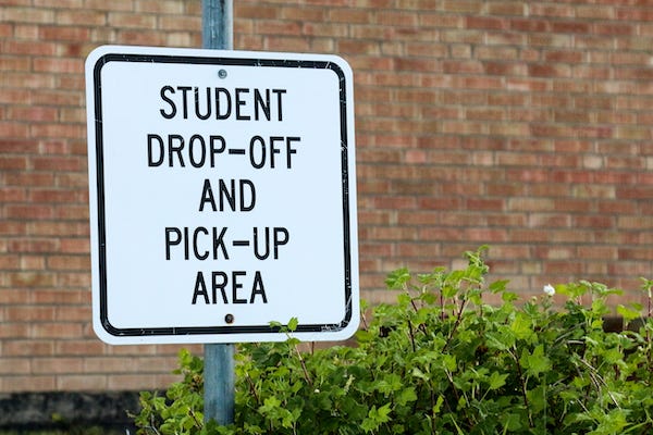 Student drop-off and pick-up area sign at school