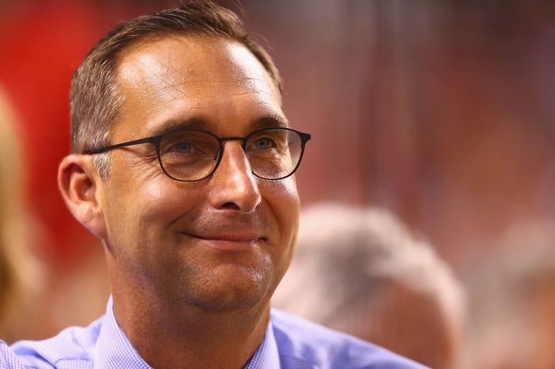 headshot of john mozeliak. he is a white man with dark hair and black glasses