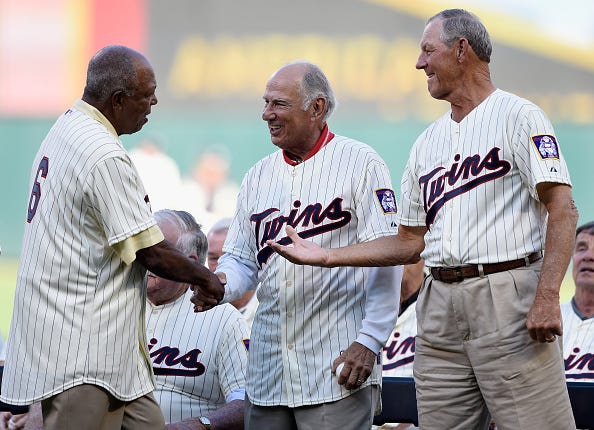 Tony Oliva, former player with the Minnesota Twins, shakes hands with former teammates Frank Quilici and Jim Kaat.