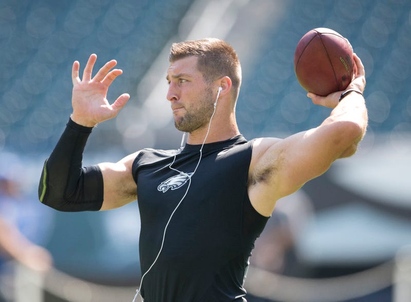 Former Eagles quarterback Tim Tebow warms up.