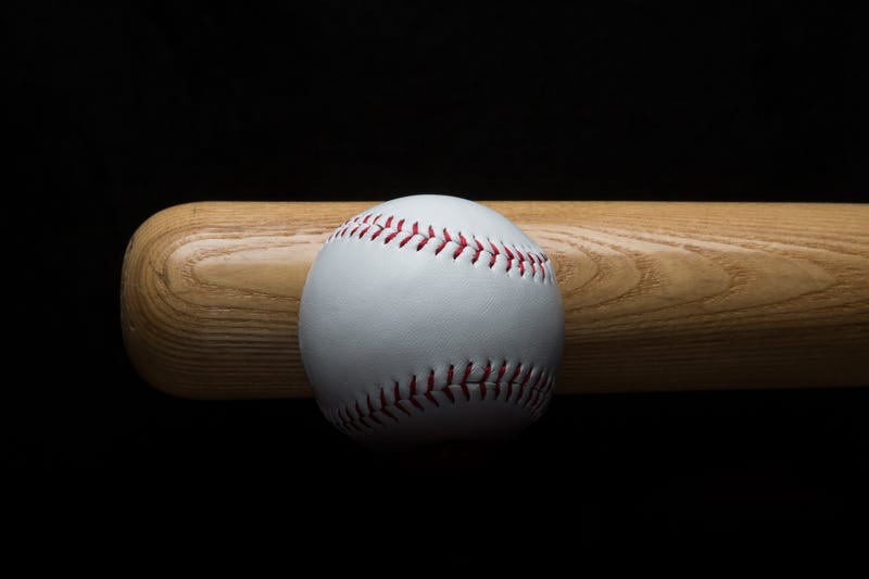 Close up photo of a baseball bat and ball