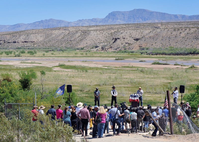 Rancher Cliven Bundy (2nd R) speaks during a news conference along the Virgin River near his ranch on April 24, 2014 in Bunkerville, Nevada.