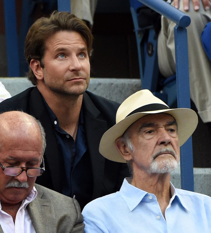 Bradley Cooper (L) and Sean Connery watch Novak Djokovic of Serbia play against Marin Cilic of Croatia during their 2015 US Open Men's Singles -Semifinals at the USTA Billie Jean King National Tennis Center September 11, 2015 in New York. 