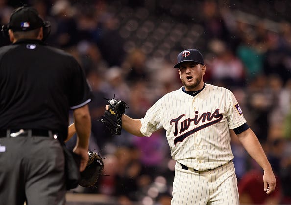 Glen Perkins #15 of the Minnesota Twins yells at home plate umpire Dan Bellino #2 after a win of the game against the Cleveland Indians on September 23, 2015 at Target Field in Minneapolis, Minnesota. The Twins defeated the Indians 4-2. 