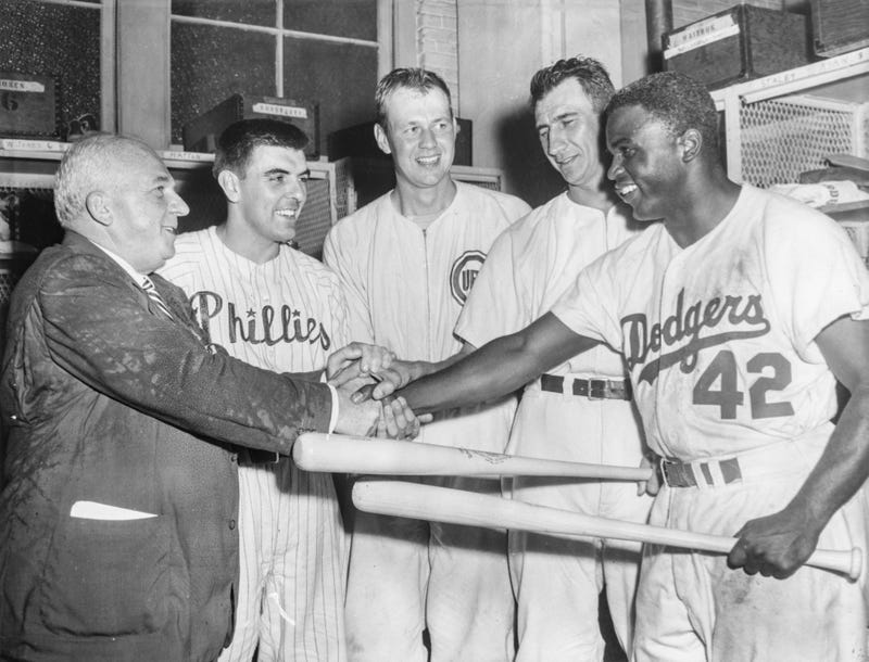 National League President Warren Giles congratulates Curt Simmons of the Philadelphia Phillies, Bob Rush and Hank Sauer of the Chicago Cubs and Jackie Robinson of the Brooklyn Dodgers after their All-Star Game win against the American League on July 8, 1952 at Shibe Park in Philadelphia, Pennsylvania.