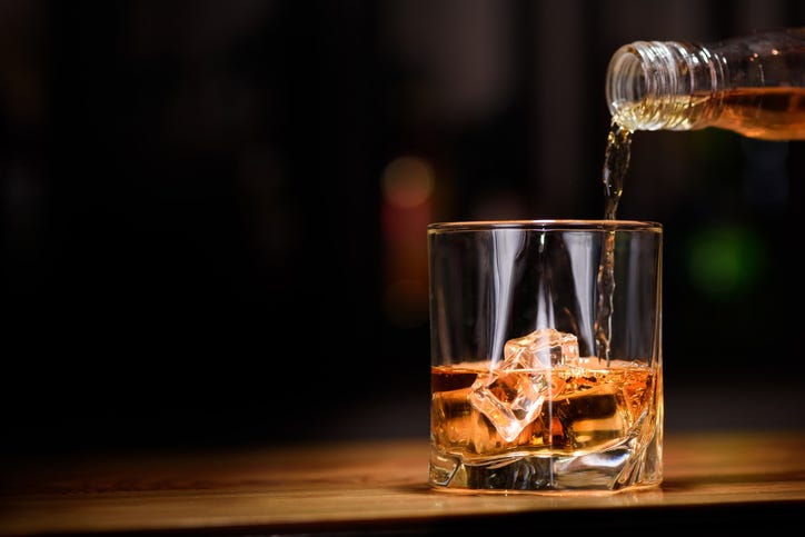 Whiskey being poured into a glass.