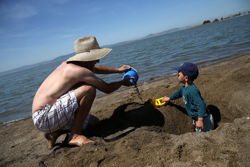 Tomasz Graczyk (L) plays with his son Vincent Graczyk-Kim (R) at Alameda Beach on May 14, 2014 in Alameda, California.