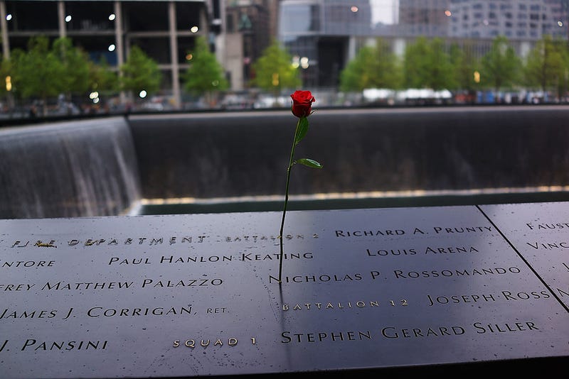 A rose is placed on a name engraved along the South reflecting pool at the Ground Zero memorial site during the dedication ceremony of the National September 11 Memorial Museum in New York May 15, 2014 in New York City. 