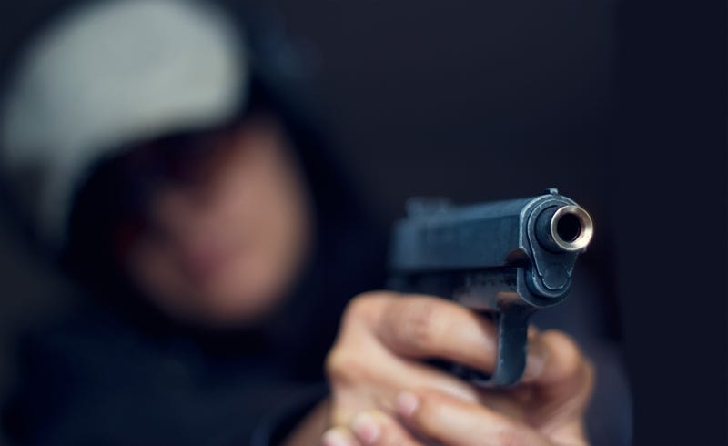 Suspect pointing a gun