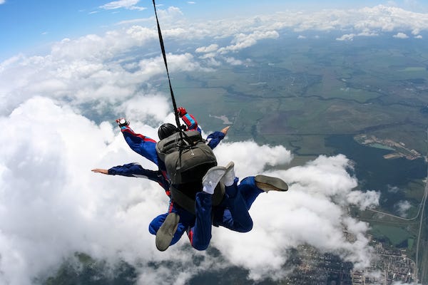 Tandem skydive above the clouds