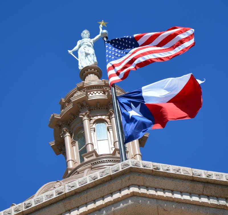 American and Texas Flags fly over Capitol