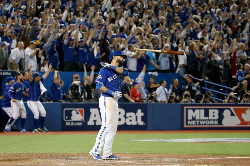 Jose Bautista #19 of the Toronto Blue Jays flips his bat up in the air after he hits a three-run home run in the seventh inning against the Texas Rangers in game five of the American League Division Series at Rogers Centre on October 14, 2015 in Toronto, Canada. 