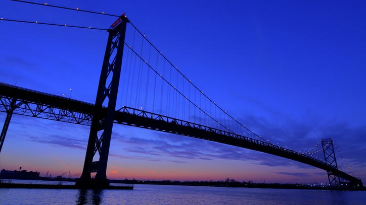Breathtaking and illegal: Viral photo shows man perched atop the Ambassador Bridge [PHOTO]