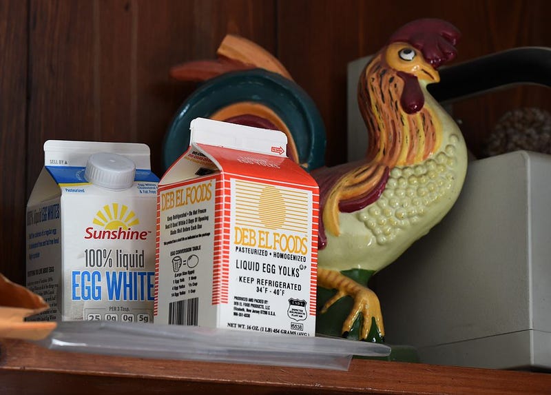 Empty egg white cartons on a book shelf next to a ceramic chicken at the Deb El processing plant in Thompsonville, New York. 