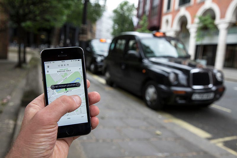 FILE - In this photo illustration, a smartphone displays the 'Uber' mobile application which allows users to hail private-hire cars from any location on June 2, 2014 in London, England.