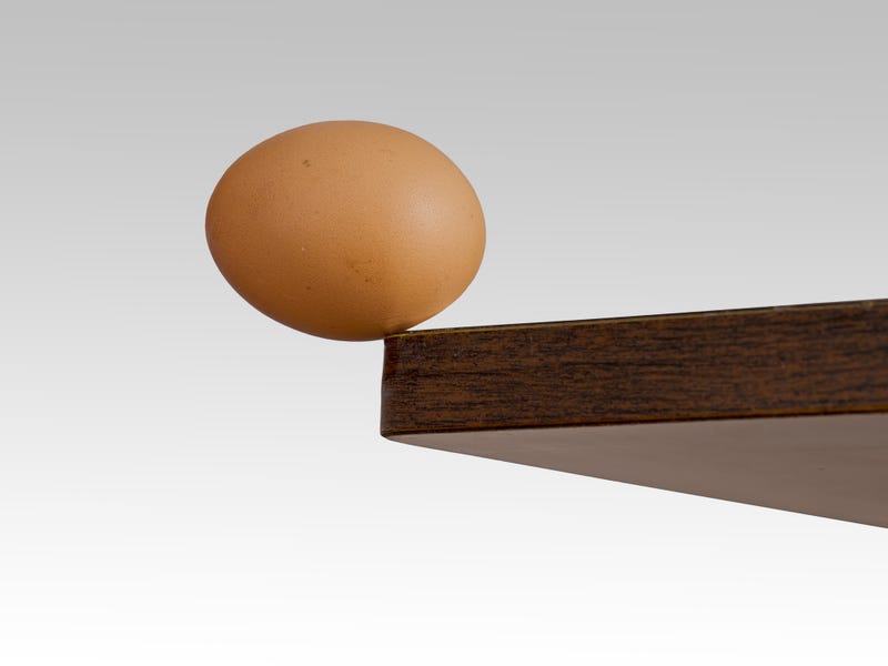 Egg on the edge of a table