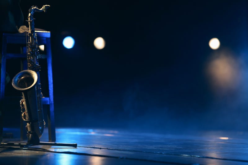 A saxophone on an empty stage.