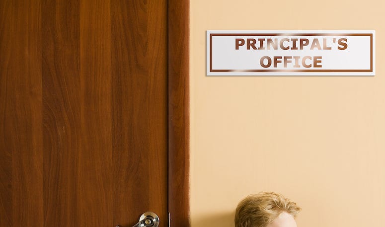 Student sitting outside principal's office