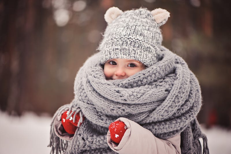 toddler child wearing red gloves, grey knitted hat and scarf