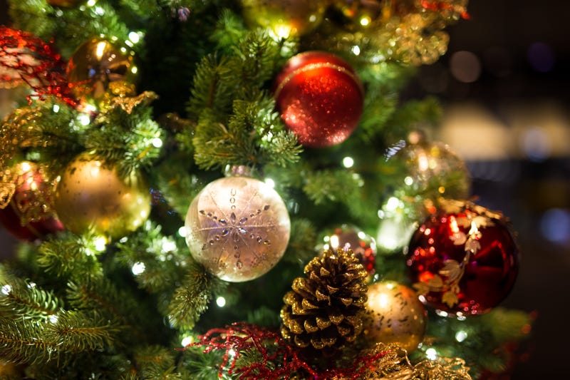 Christmas ornaments hang from a tree