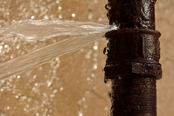 Cracked water pipe spraying water