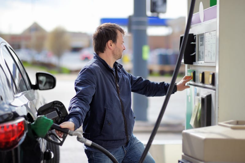 Man filling gasoline fuel in car
