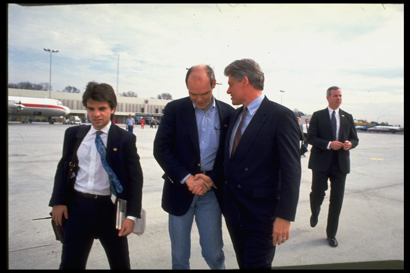 Then-Democratic presidential hopeful Arkansas Gov. Bill Clinton (R) walking airport tarmac w. then-aides George Stephanopoulos (L) & strategist James Carville, conferring w. latter, during primary campaign.