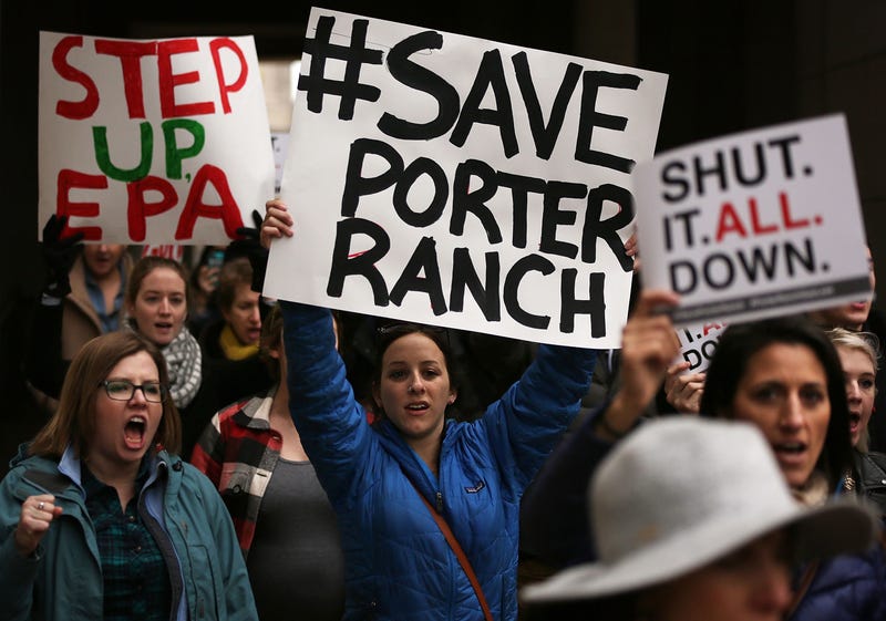 protesters with signs that say save porter ranch and shut it all down