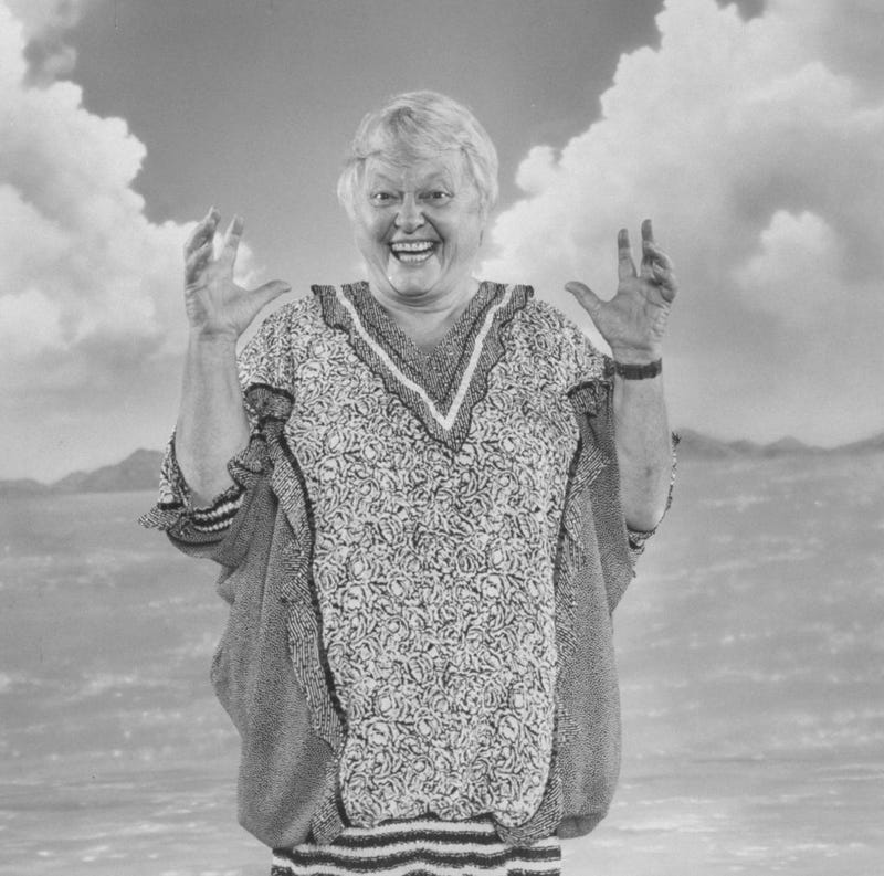 Actress Pat Carroll engaged in a mock scream in front of ocean scene backdrop as the voice of the sea witch Ursula for the movie The Little Mermaid.