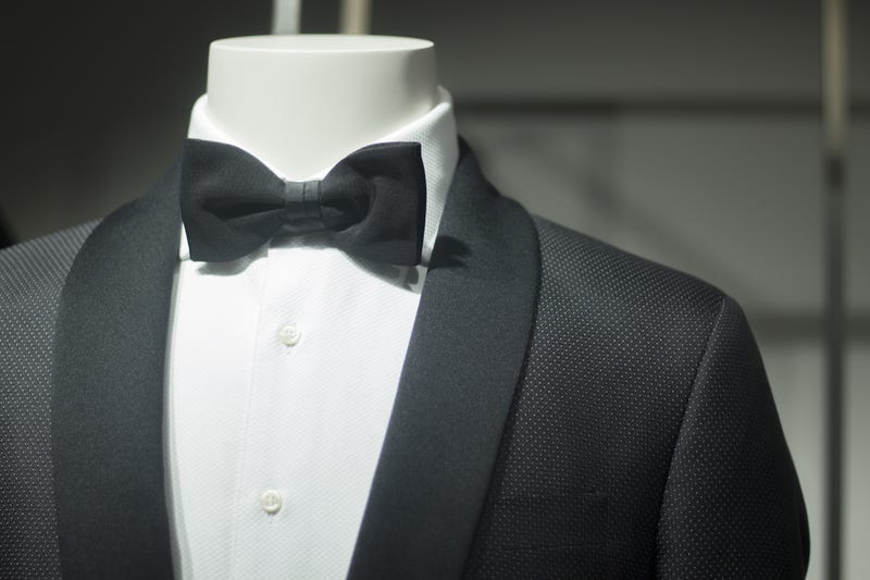 fashion mannequin in department store boutique window wearing evening suit dinner jacket and bow tie