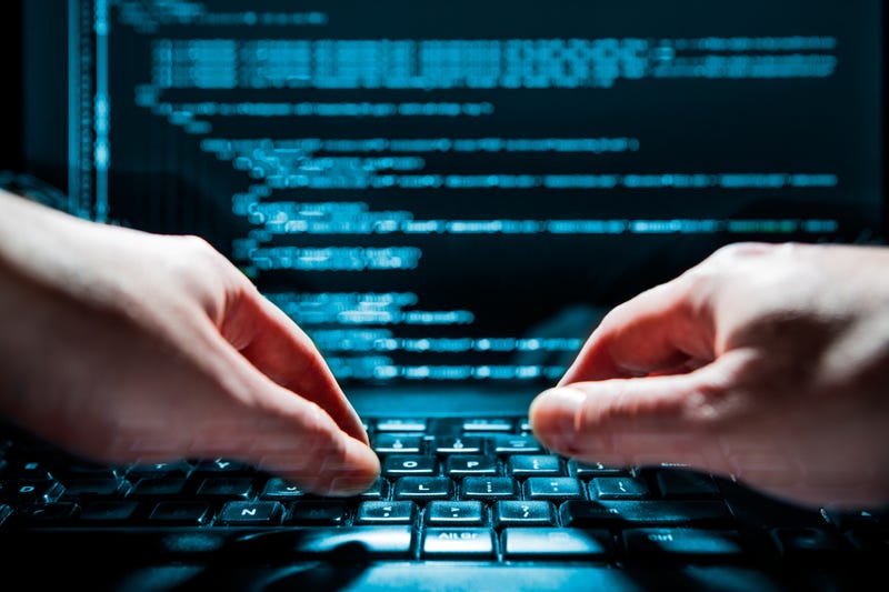 Hands typing on computer