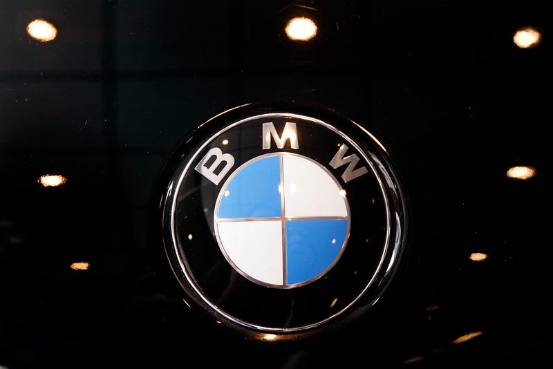 A BMW badge decorates the hood of a 330i.