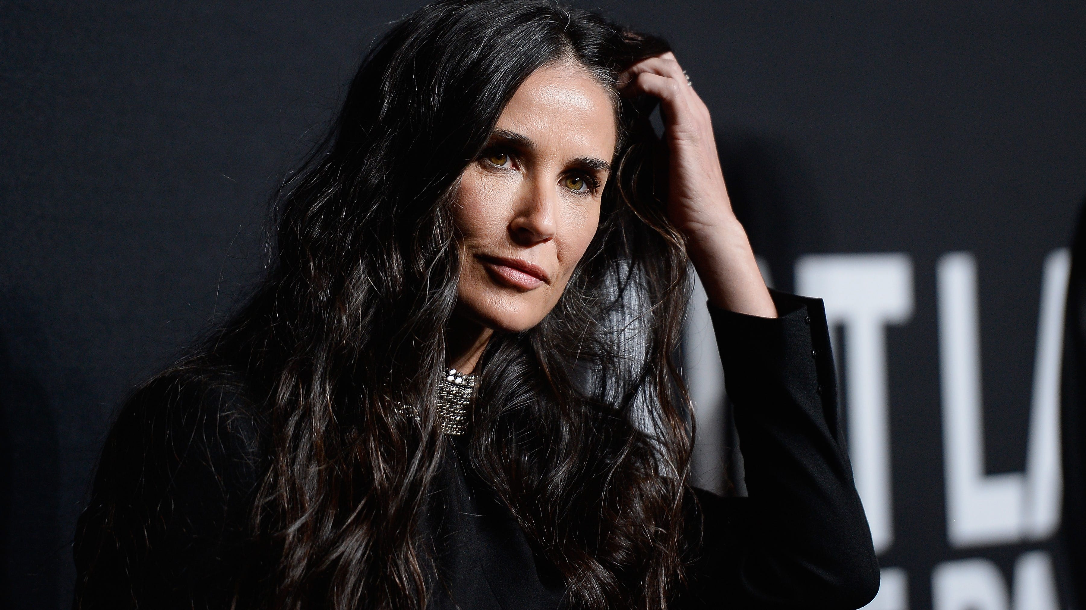 Demi Moore, 59, takes a dip in bright white swimsuit