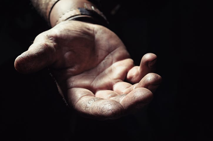 Hand emerging from the dark