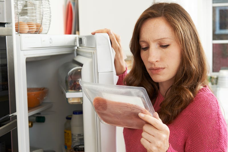 woman looking at food label