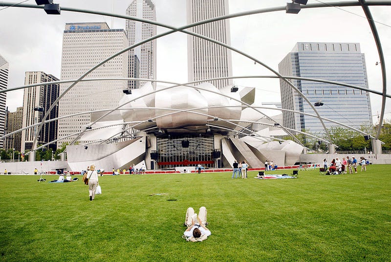 Chicago residents and tourists explore the Pritzker Pavilion designed by famed architect Frank Gehry in the newly opened Millennium park July 16, 2004 in Chicago Illinois. The park which covers just over 24 acres cost nearly $500 million to build.