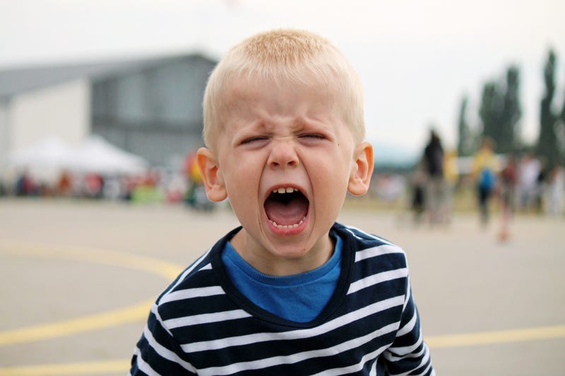 child having a melt down at a football tailgate