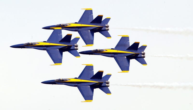 Members of the U.S. Navy Blue Angels do a maneuver as they fly over Lake Michigan August 22, 2004 in Chicago, Illinois. The U.S. Navy Blue Angels were one of many airplane groups that participated in the 46th annual Chicago Air and Water Show in the skies over Chicago's Lake Michigan.