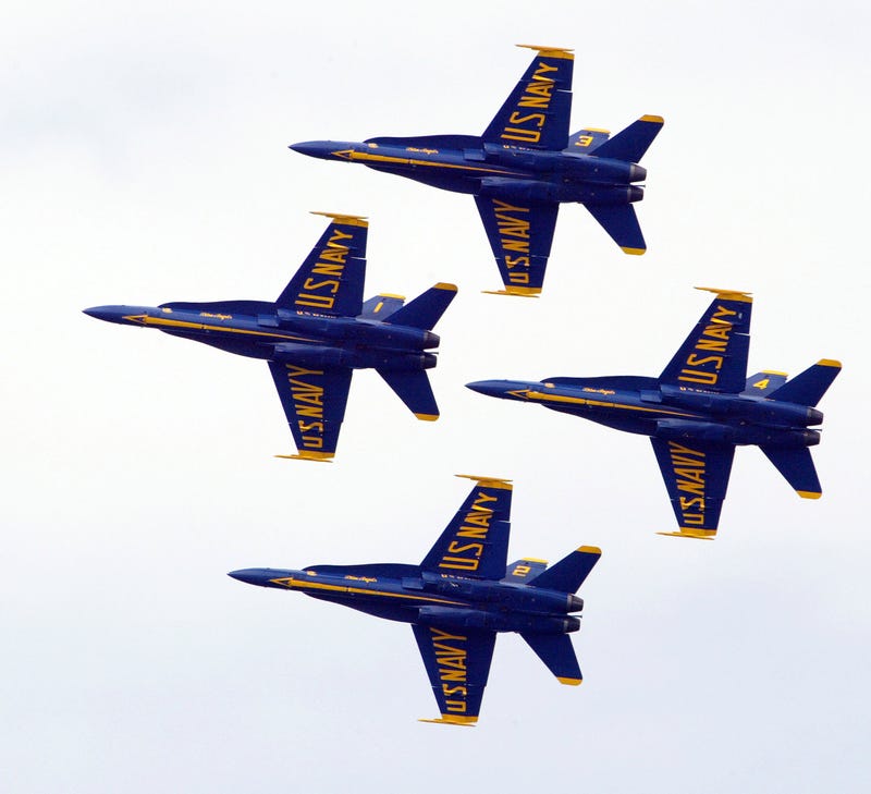 Members of the U.S. Navy Blue Angels do a maneuver as they fly over Lake Michigan August 22, 2004 in Chicago, Illinois. The U.S. Navy Blue Angels were one of many airplane groups that participated in the 46th annual Chicago Air and Water Show in the skies over Chicago's Lake Michigan.