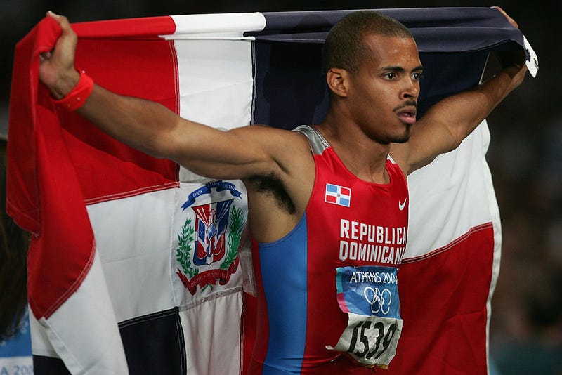 Felix Sanchez of the Dominican Republic celebrates after he won gold the men's 400 metre hurdle final on August 26, 2004 during the Athens 2004 Summer Olympic Games