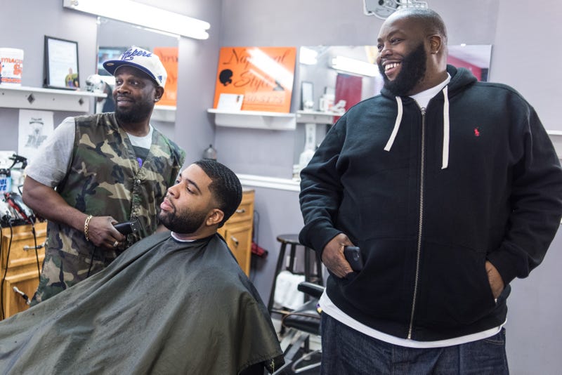 COLUMBIA, SC - FEBRUARY 26, 2016: Rapper Killer Mike, right, talks about the upcoming South Carolina Democratic presidential primary at Smoke's Barber Shop as Donnell McDaniel, left, gives Ryan Norris a hair cut Friday, February 26, 2016 in Columbia, South Carolina. Michael Render, aka Killer Mike, campaigned for Democratic presidential candidate Bernie Sanders in the state capital the day before voters participate in the state's primary election. (Photo by Sean Rayford/Getty Images)