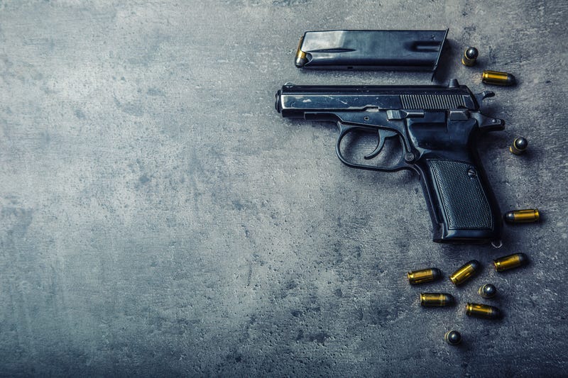 gun and bullets on a table