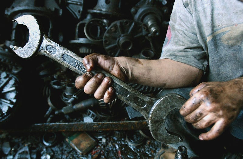  Mustafa, 4, holds a wrech in an automobile mechanic shop owned by his father September 29, 2004 in Baghdad, Iraq. War and poverty pushed large numbers of Iraqi children out of school and into work to support their families according to a study by conducted UNICEF after major combat ended last year.